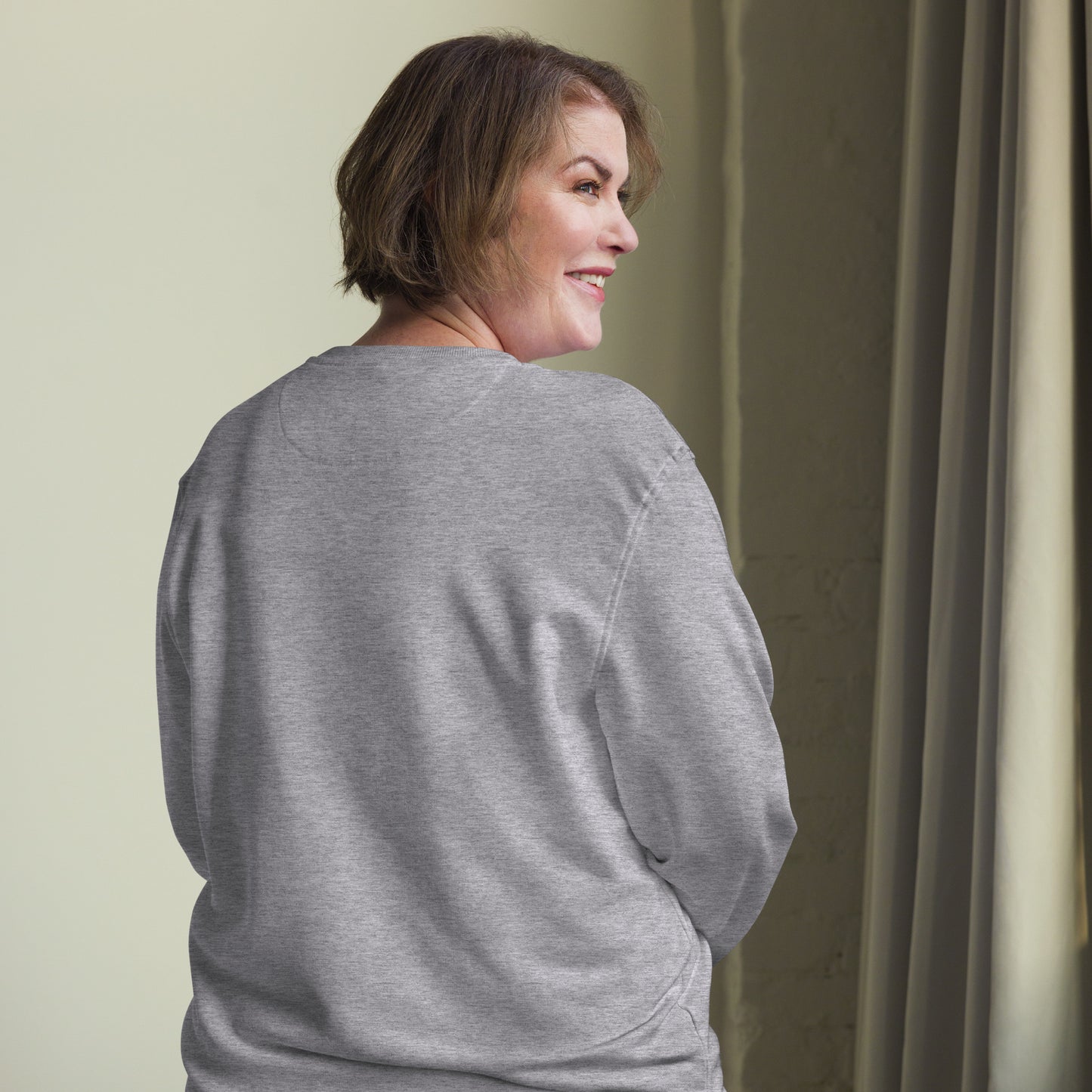 Minimalist sun graphic with 'Light Returns Novapuro' text on a grey or white eco-friendly organic cotton sweatshirt.