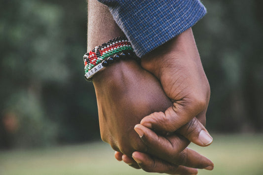 A diverse group of people joining hands in a circle, symbolizing global unity and community support.