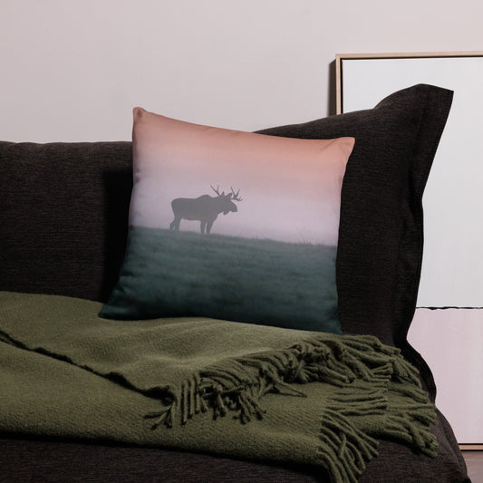 A stylish premium throw pillow featuring a distressed splash-edge print of a majestic bull moose by Mikko Monto, placed in a cozy home setting.