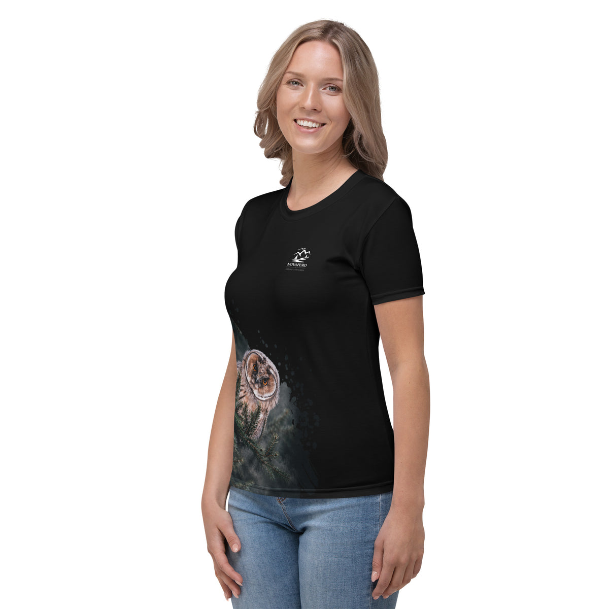 A woman wearing the black Novapuro x Jarno Virtanen women's t-shirt featuring a Nordic long-eared owl chick print on the lower side.