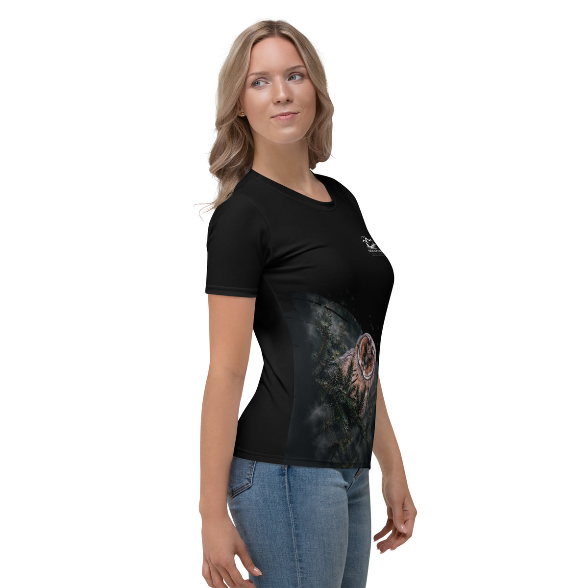 A woman wearing the black Novapuro x Jarno Virtanen women's t-shirt featuring a Nordic long-eared owl chick print on the lower side.