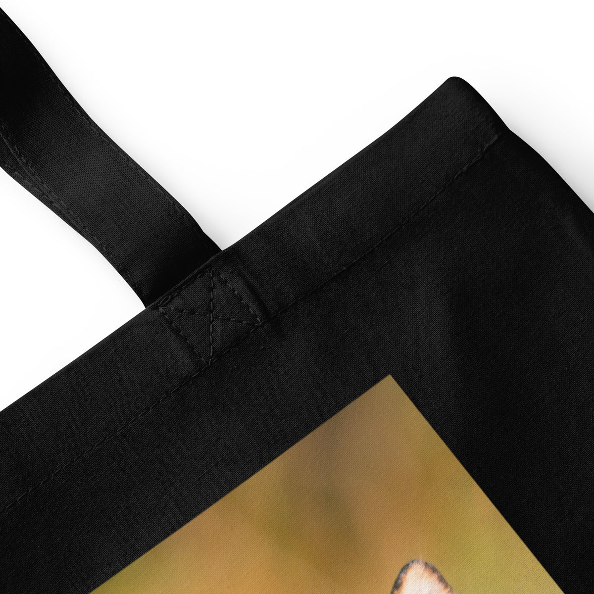 Close-up view of the black durable cotton tote bag showcasing the medium-length carrying handles and spacious design