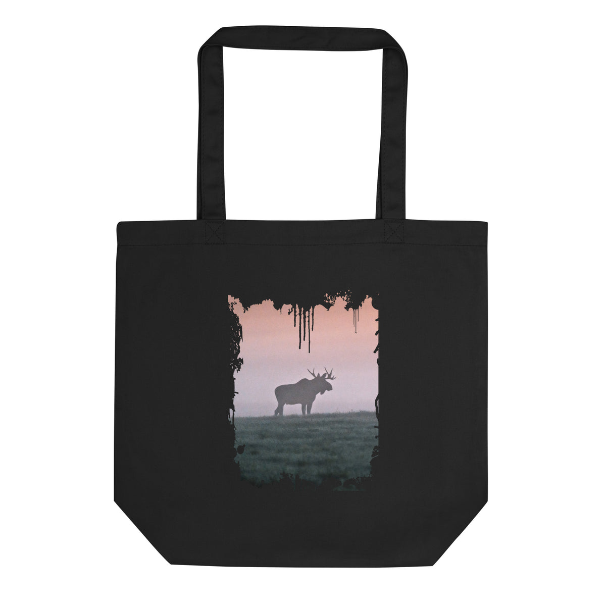 A person carrying a black sustainable organic cotton tote bag, featuring a distressed splash-edge front print of a majestic bull moose by Mikko Monto