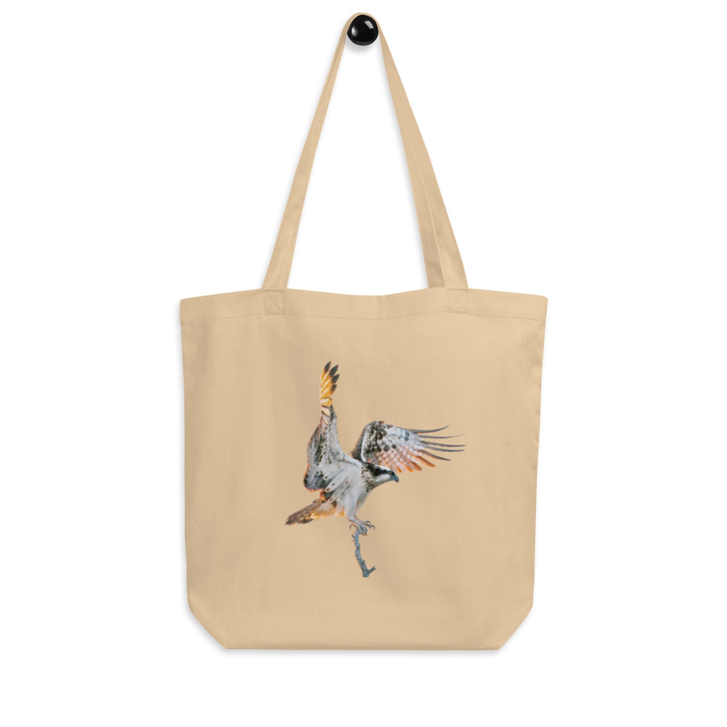 A natural color organic cotton tote bag by Novapuro featuring a dynamic flying osprey wildlife photograph by Mikko Monto.