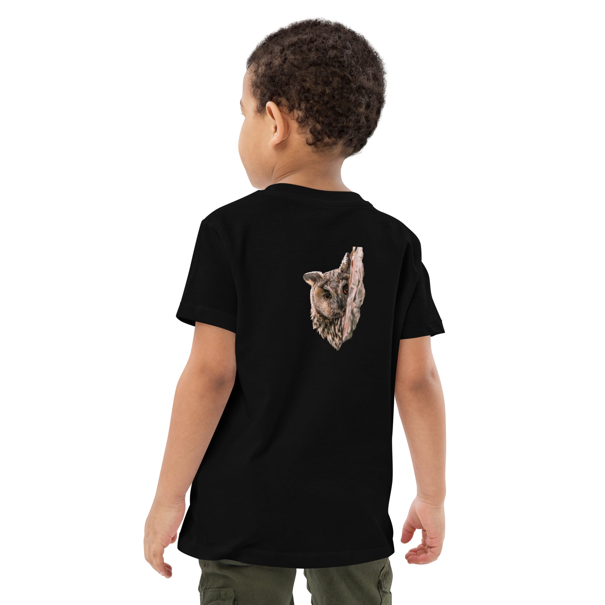 Back view of a child wearing a black organic t-shirt featuring a stippling art print of a Long-eared Owl by Mikko Monto.