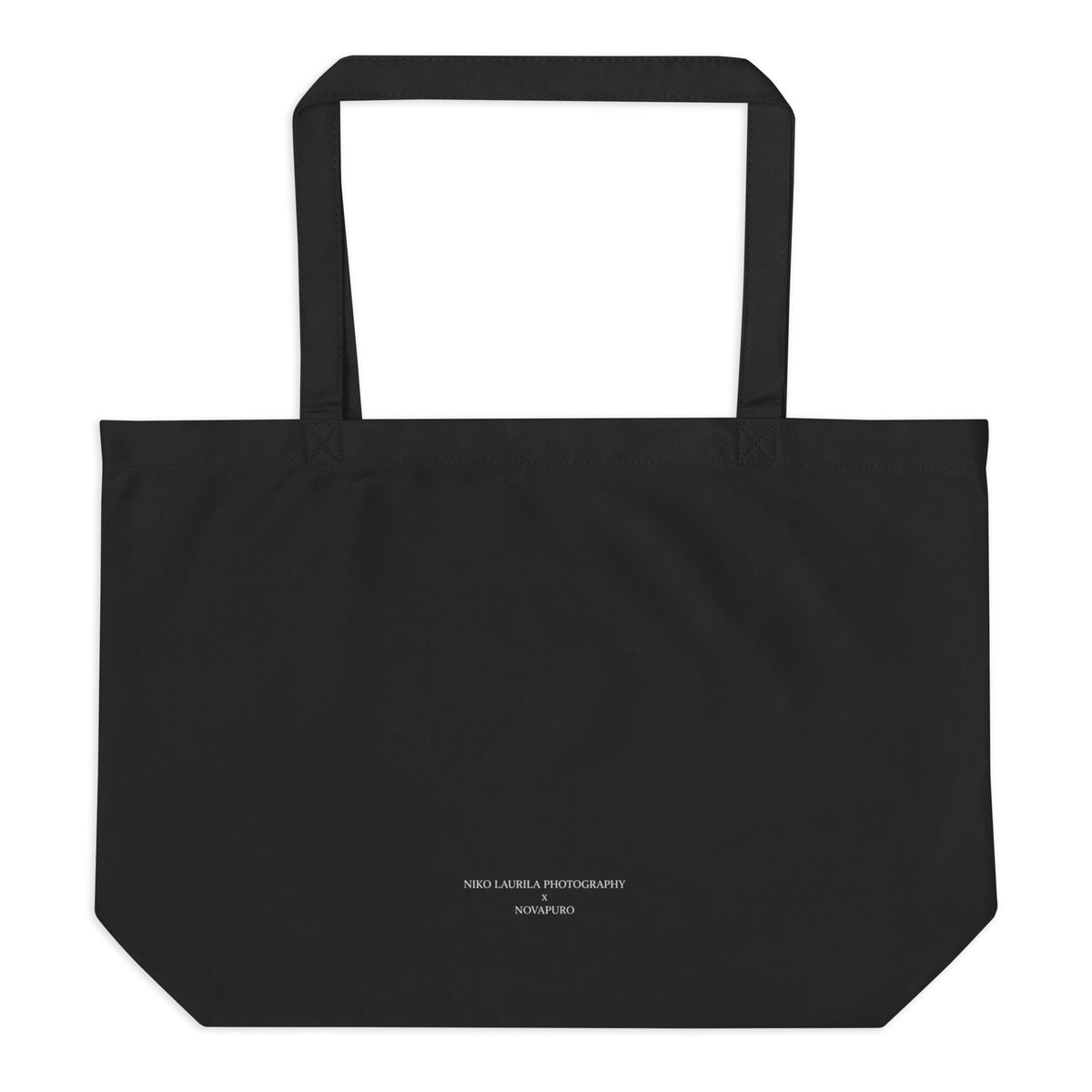 Back view of the durable black organic eco tote bag, showing the sturdy self-fabric dual straps and flat bottom design.   