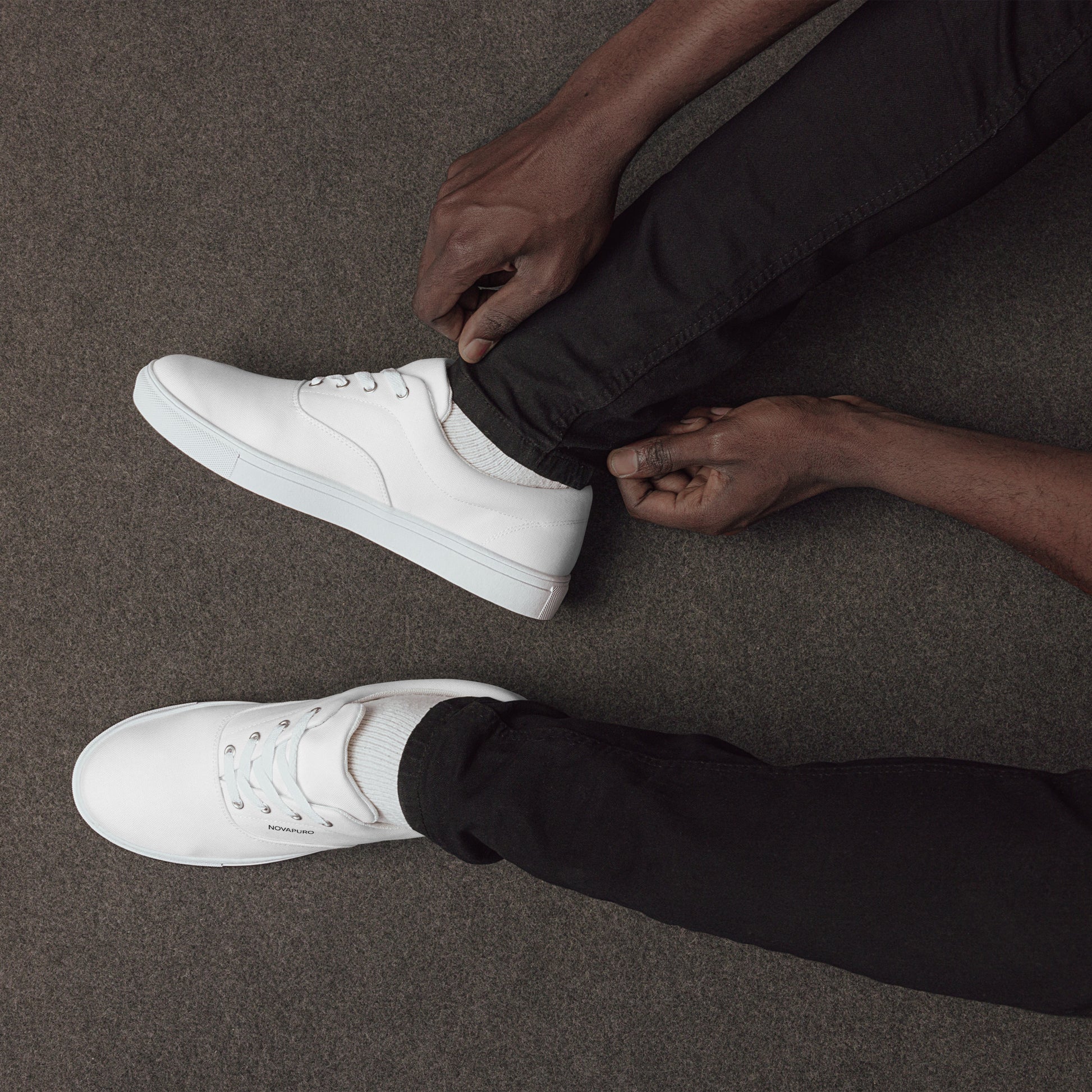 Minimalist charcoal grey men's canvas sneakers with clean white NOVAPURO branding and horizon line design