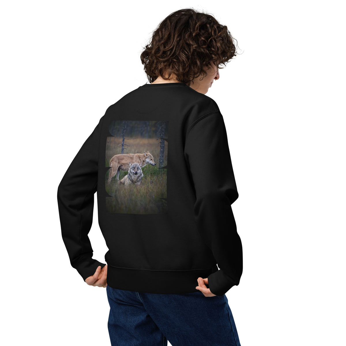 model wearing a black unisex organic cotton sweatshirt featuring the 'Leaders of the Pack' alpha wolf couple back print. Sustainable Nordic nature apparel.   