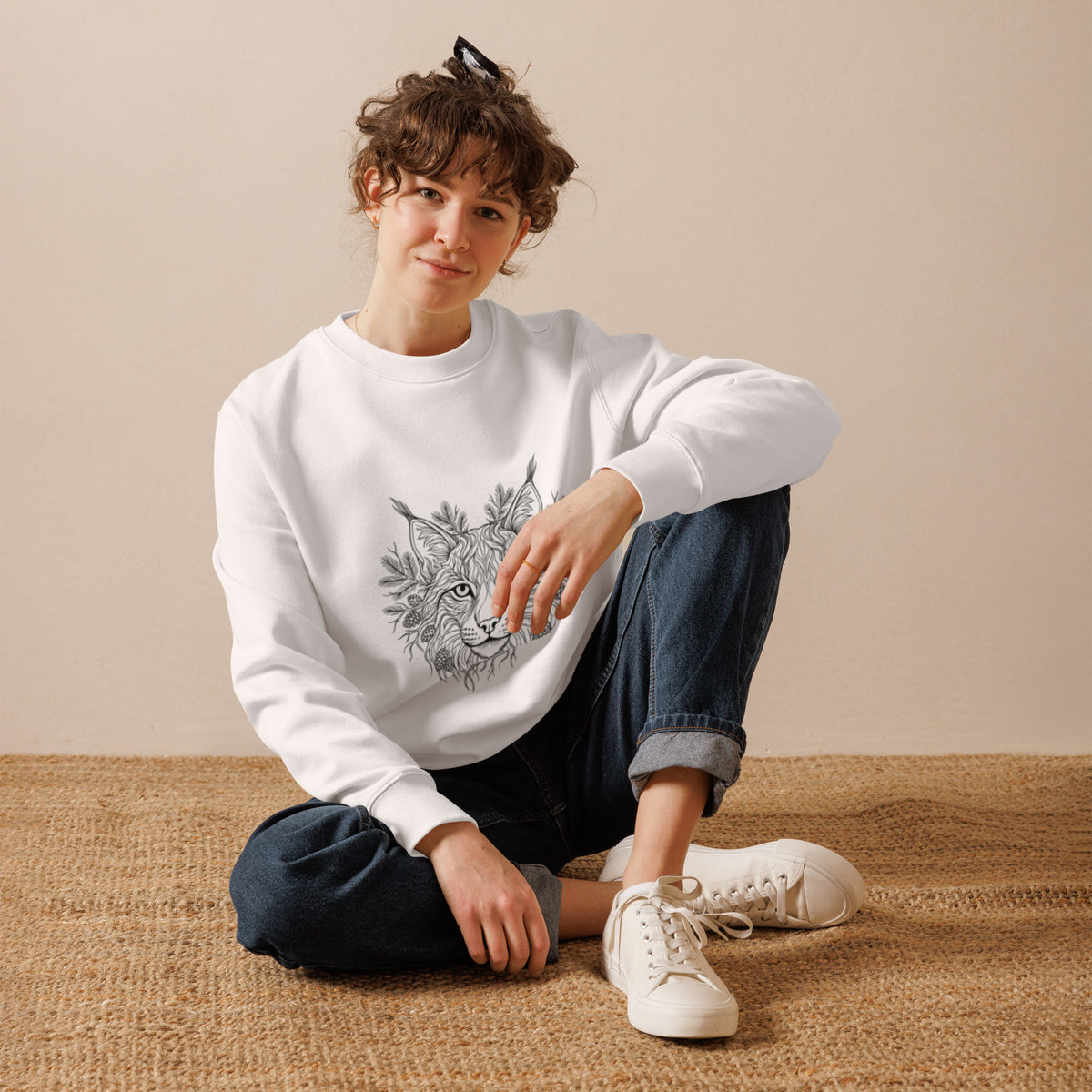 Lifestyle shot of a person wearing the sustainable Novapuro Nordic lynx organic cotton sweatshirt in white, highlighting eco-friendly Scandinavian streetwear.