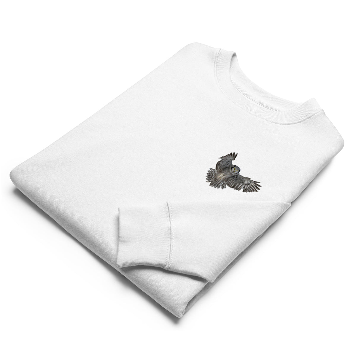 Front view of a person wearing a white unisex organic eco sweatshirt featuring a small Northern Hawk Owl print on the left chest by Annette Thome Marttinen x Novapuro.