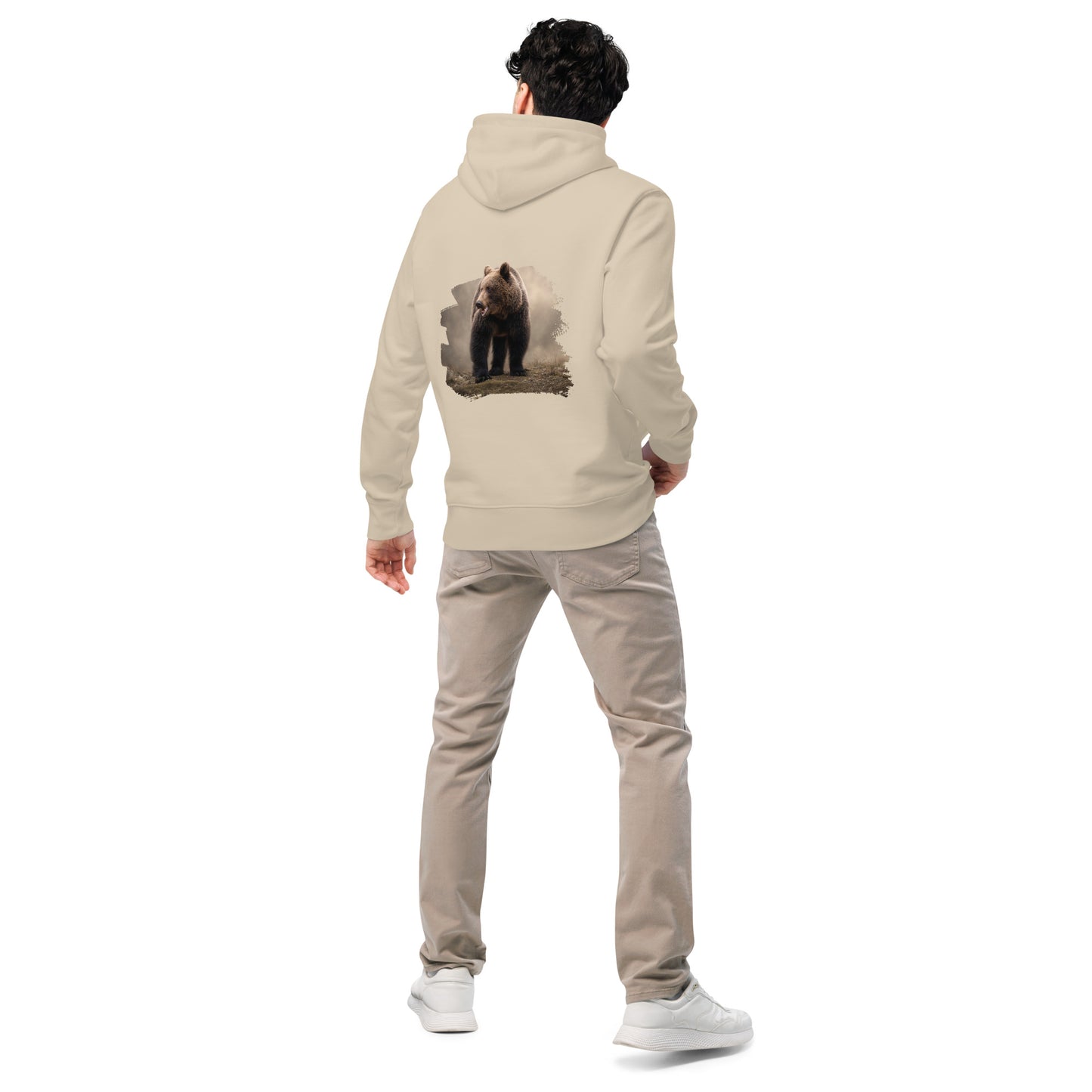 Man wearing a Desert Dust sand-colored Novapuro x Jarno Virtanen organic hoodie featuring a detailed brown bear artwork on the back, studio shot