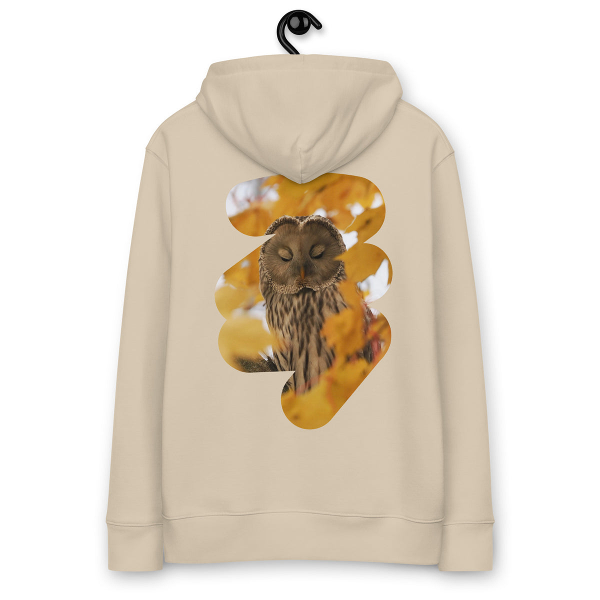 Eco-conscious woman wearing the Ural Owl Organic Eco Hoodie in the Nordic wilderness, showcasing fine art nature photography on the back.