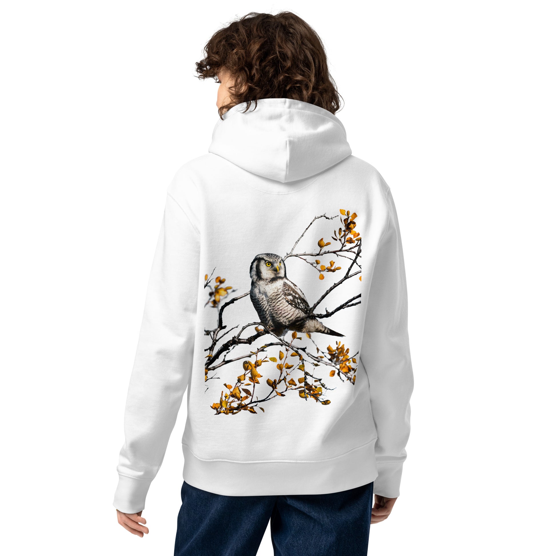 Back view of a female model wearing the white Jetro Luhtaa x Novapuro organic hoodie featuring a stunning Nordic owl back print.