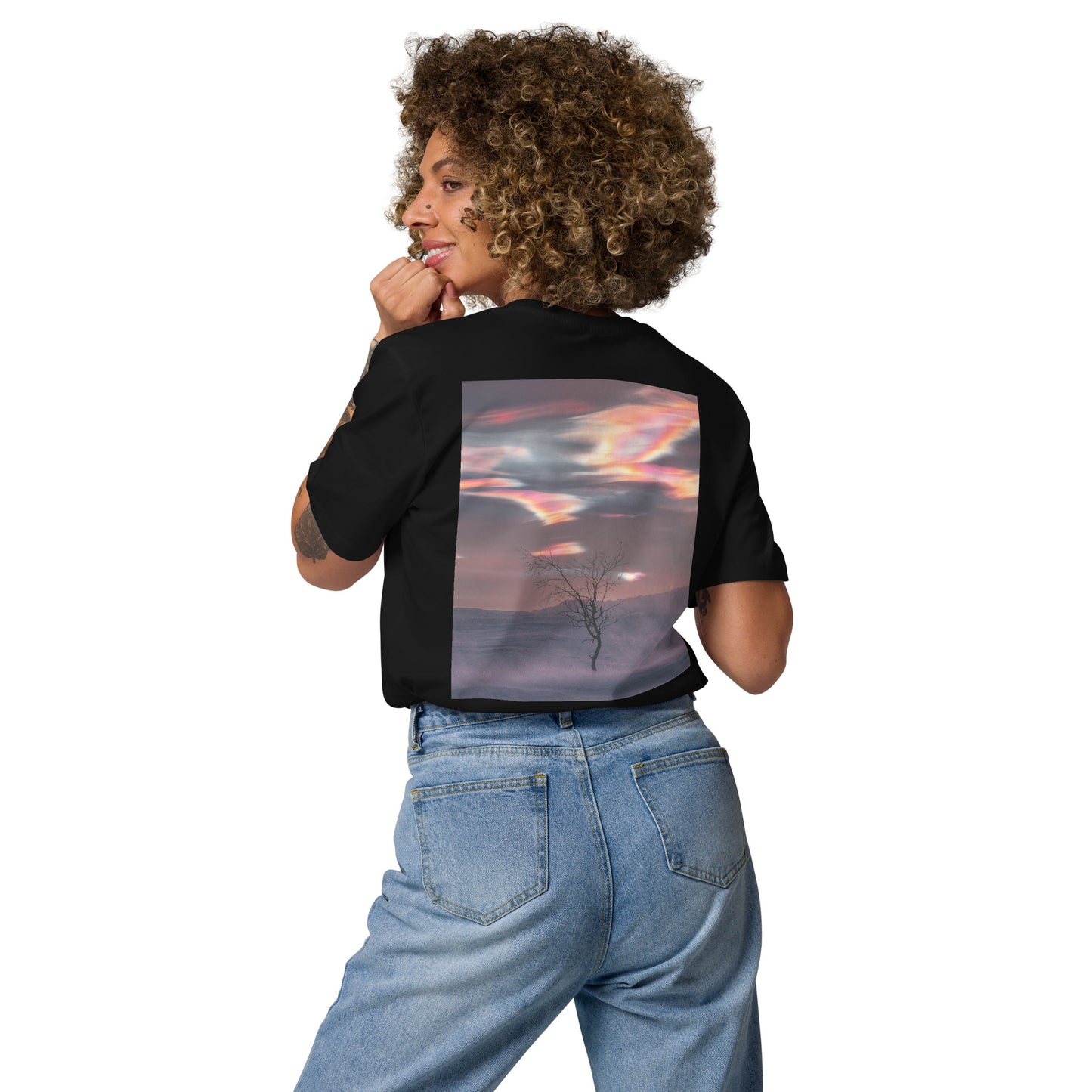 Back view of a female model wearing the black Jetro Luhtaa x Novapuro organic cotton t-shirt featuring a vibrant nacreous clouds photography print.