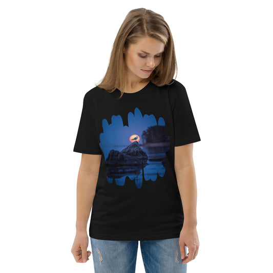A person wearing a black sustainable organic cotton t-shirt featuring the 'Nordic Sunrise' wildlife silhouette photography by Niko Laurila.
