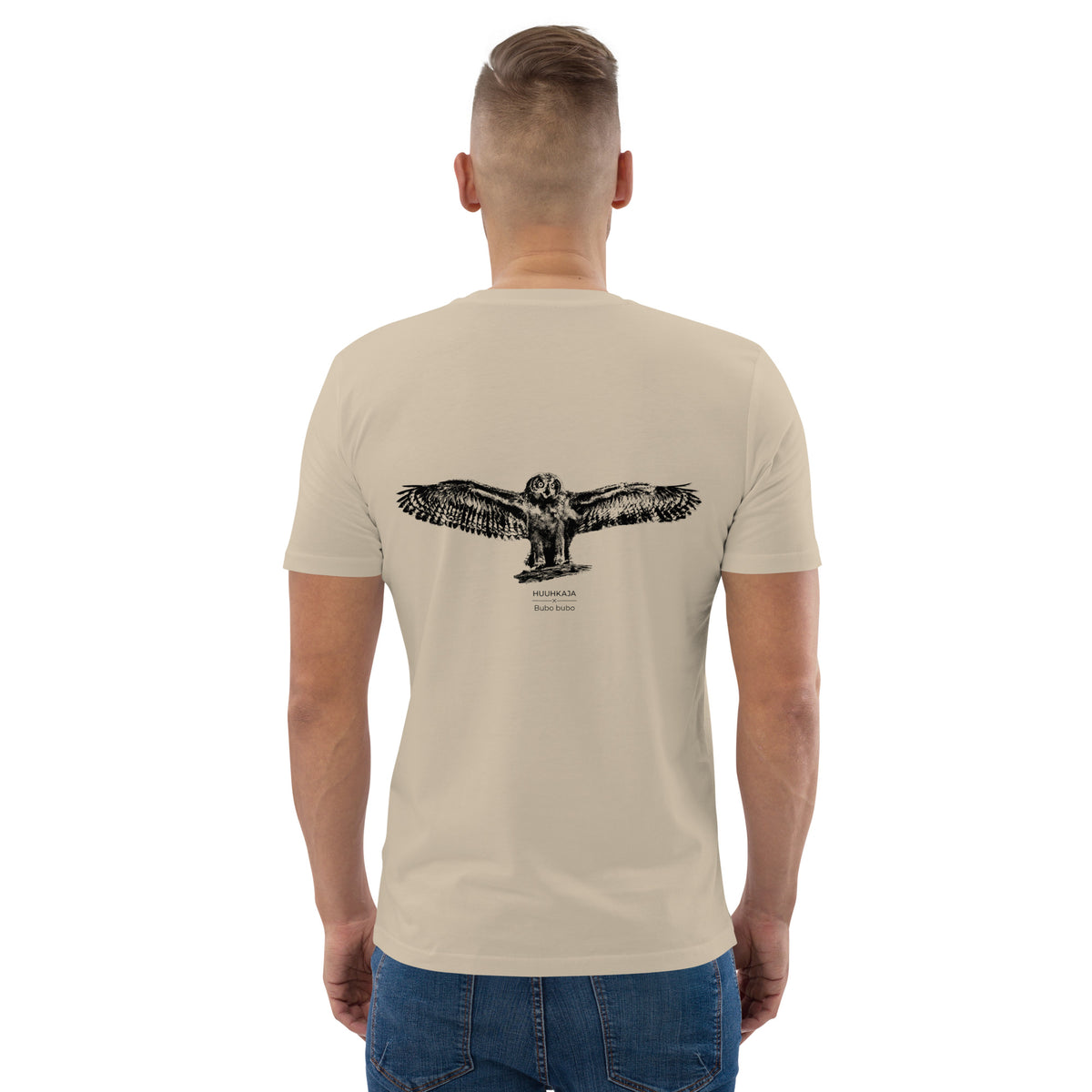 Man wearing a sustainable beige organic cotton t-shirt, showcasing "The Threshold" Eagle Owl Nordic wildlife graphic on the back. Designed by Jarno Virtanen for ethical and comfortable everyday wear.