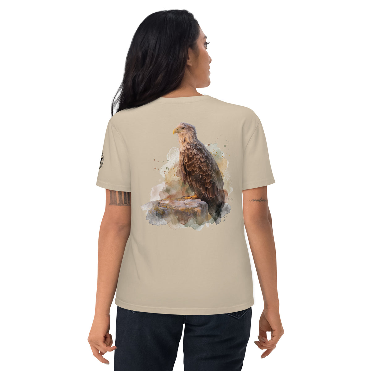Back view of a person wearing a desert-colored organic cotton t-shirt featuring an artistic white-tailed eagle wildlife print by Annette Thome Marttinen x Novapuro.