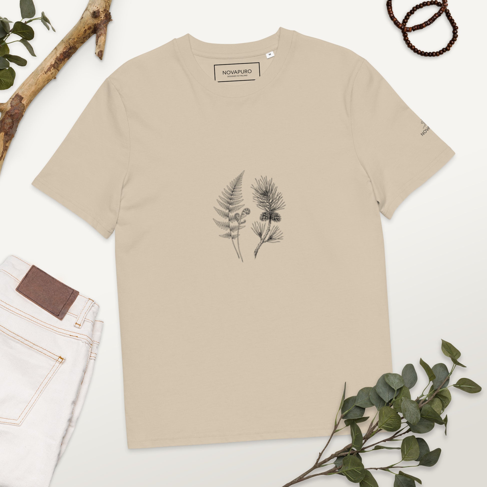 Minimalist line art illustration of a fern and pine branch on a beige Desert Dust organic cotton t-shirt, representing sustainable Nordic fashion by Novapuro.