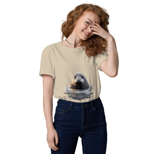 A female model wearing a sand-colored sustainable organic cotton t-shirt featuring a Saimaa ringed seal graphic, offering premium eco-friendly streetwear for nature lovers.