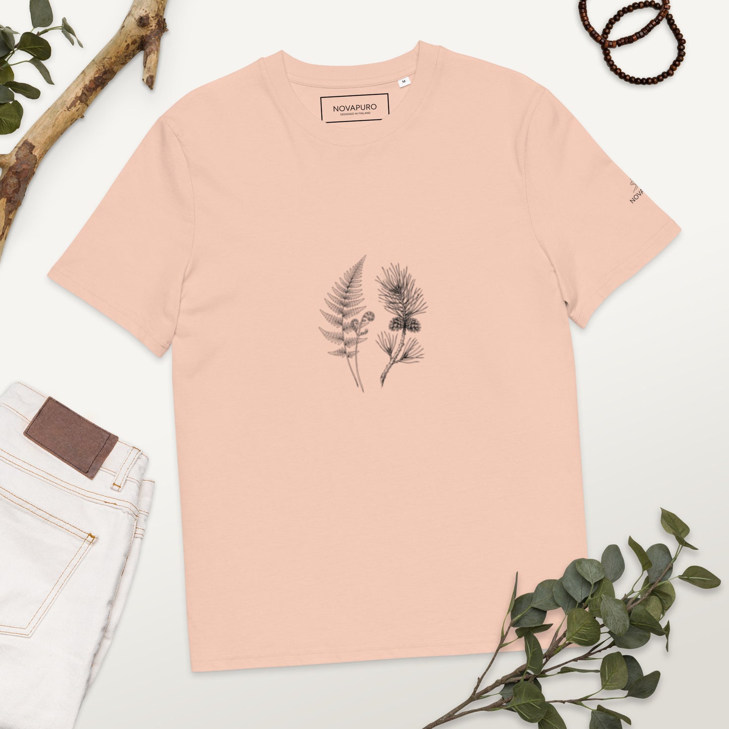 Minimalist line art illustration of a fern and pine branch on a light peach Fraiche Peche organic cotton t-shirt, representing sustainable Nordic fashion by Novapuro.