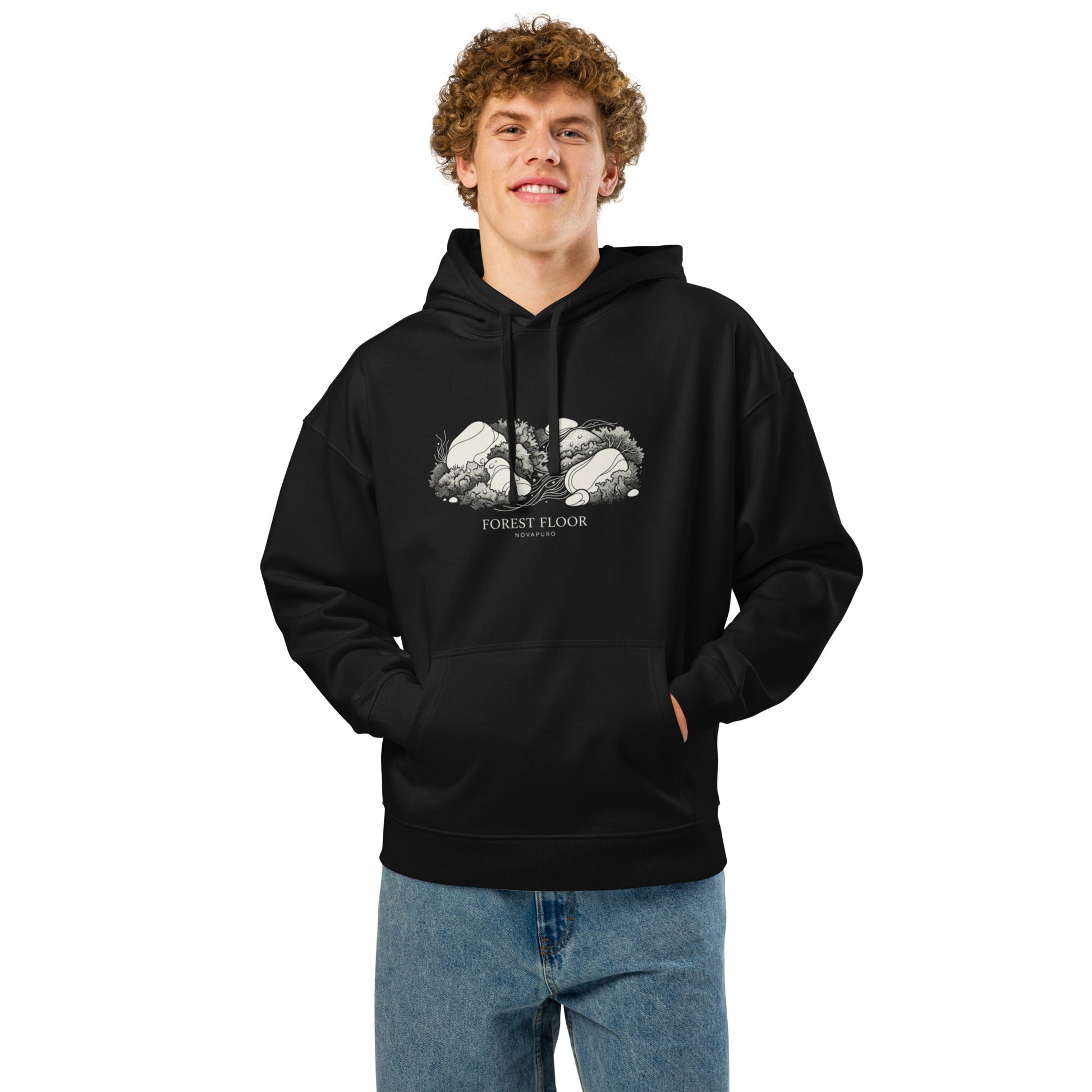 A black premium organic relaxed hoodie featuring a textured white illustration of Nordic forest moss and stones with the text Forest Floor Novapuro.