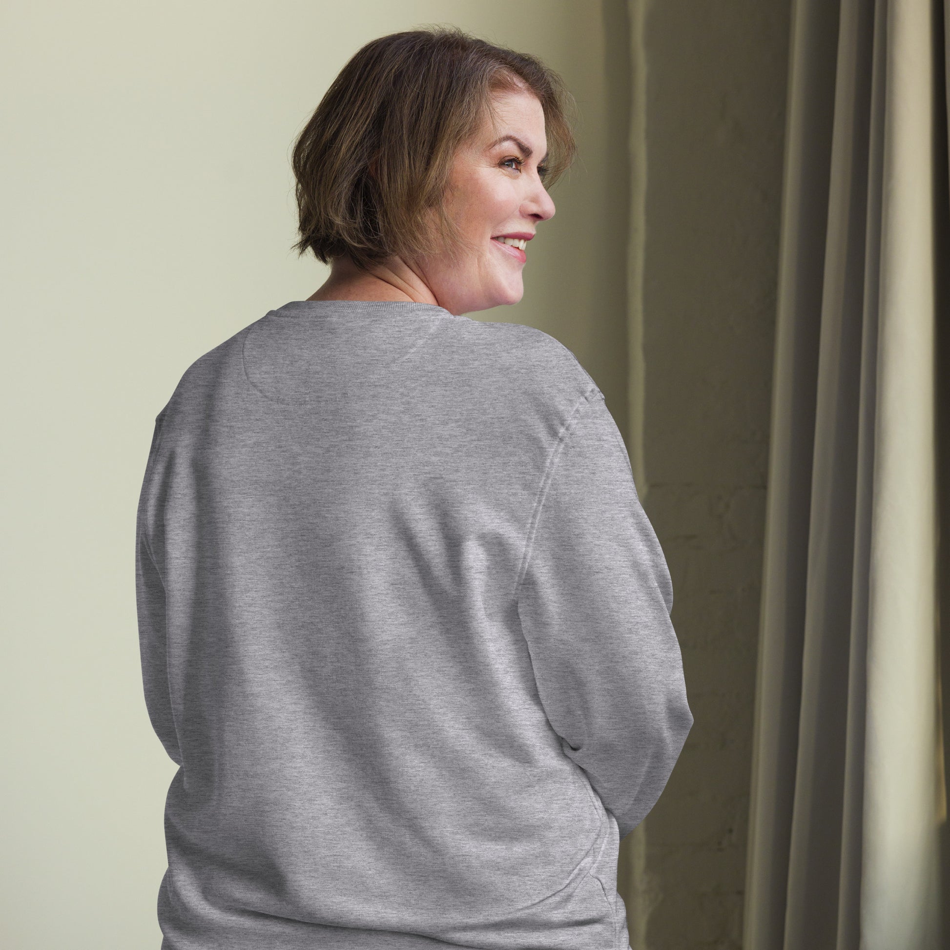 Minimalist sun graphic with 'Light Returns Novapuro' text on a grey or white eco-friendly organic cotton sweatshirt.