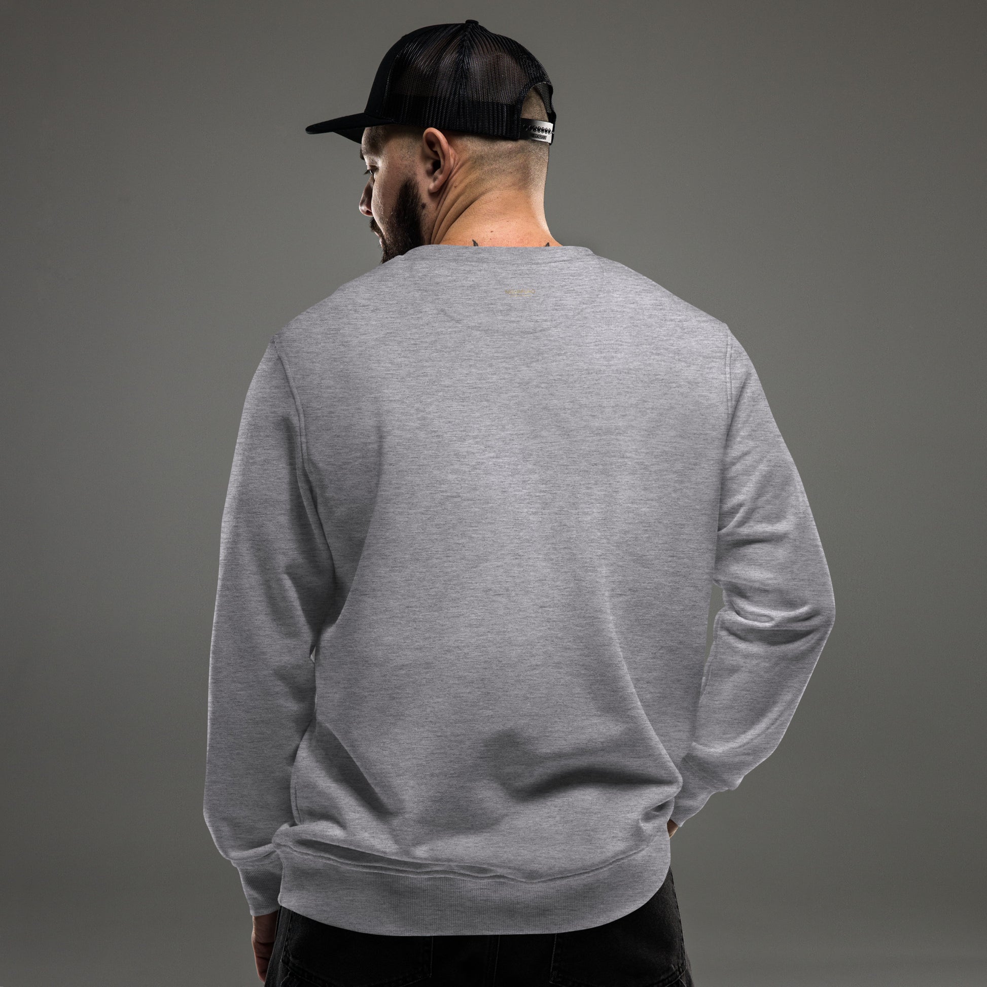 Back view of a man wearing a grey eco-friendly organic sweatshirt, ideal for modern outdoor Nordic style.