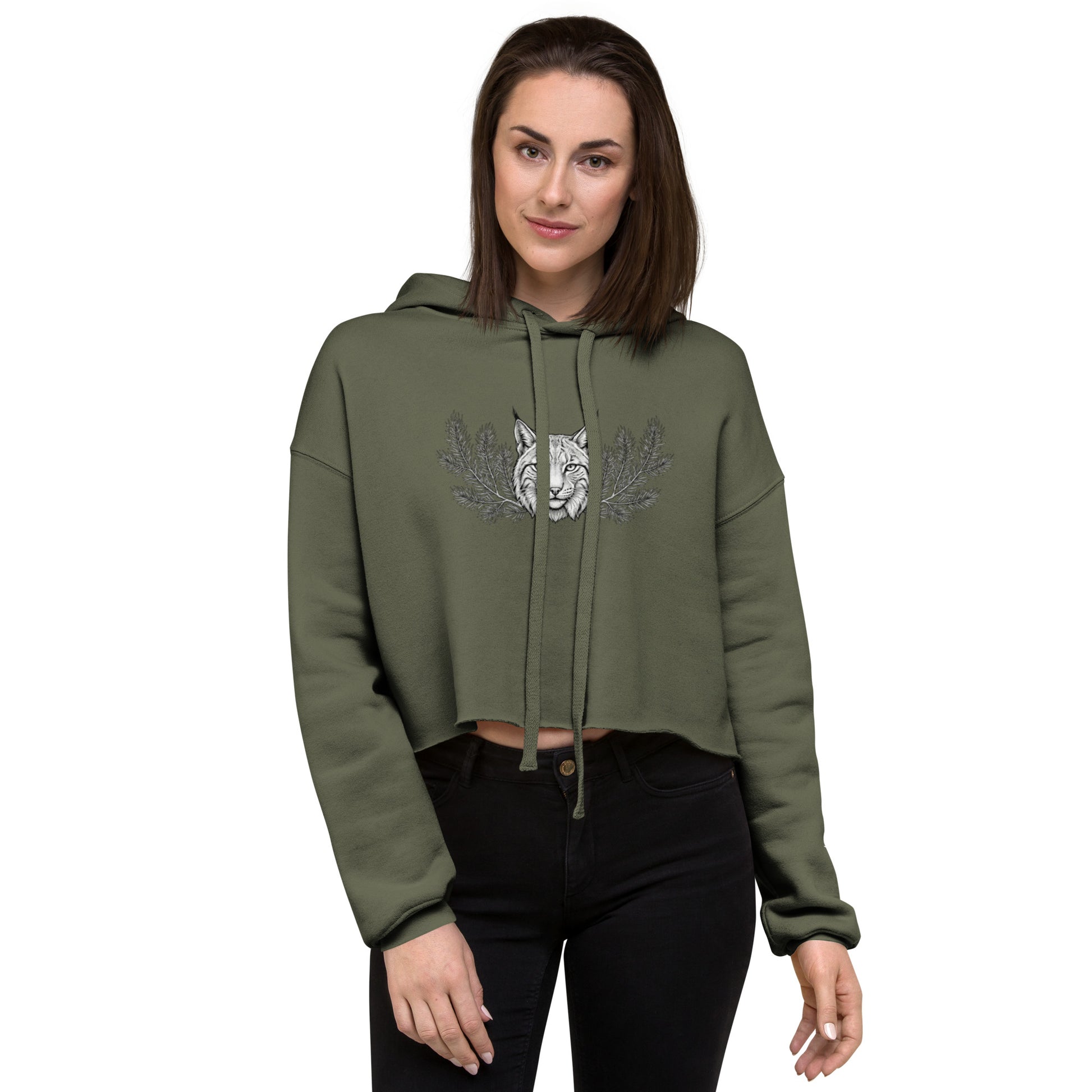Woman wearing a military green cropped hoodie featuring a mystical Nordic lynx illustration. Trendy raw hem fleece pullover with a detailed black and white forest ghost design.