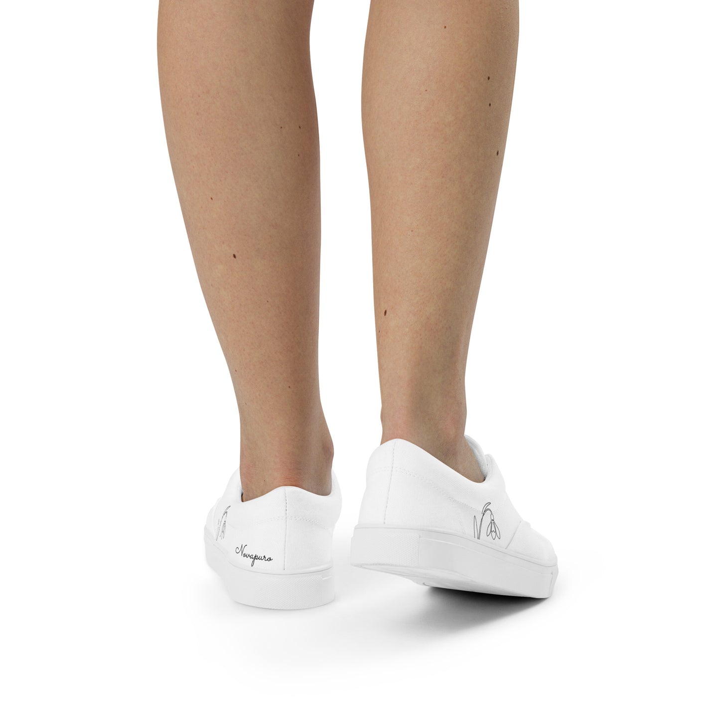 Minimalist white women's canvas sneakers with black First Bloom snowdrop design by Novapuro