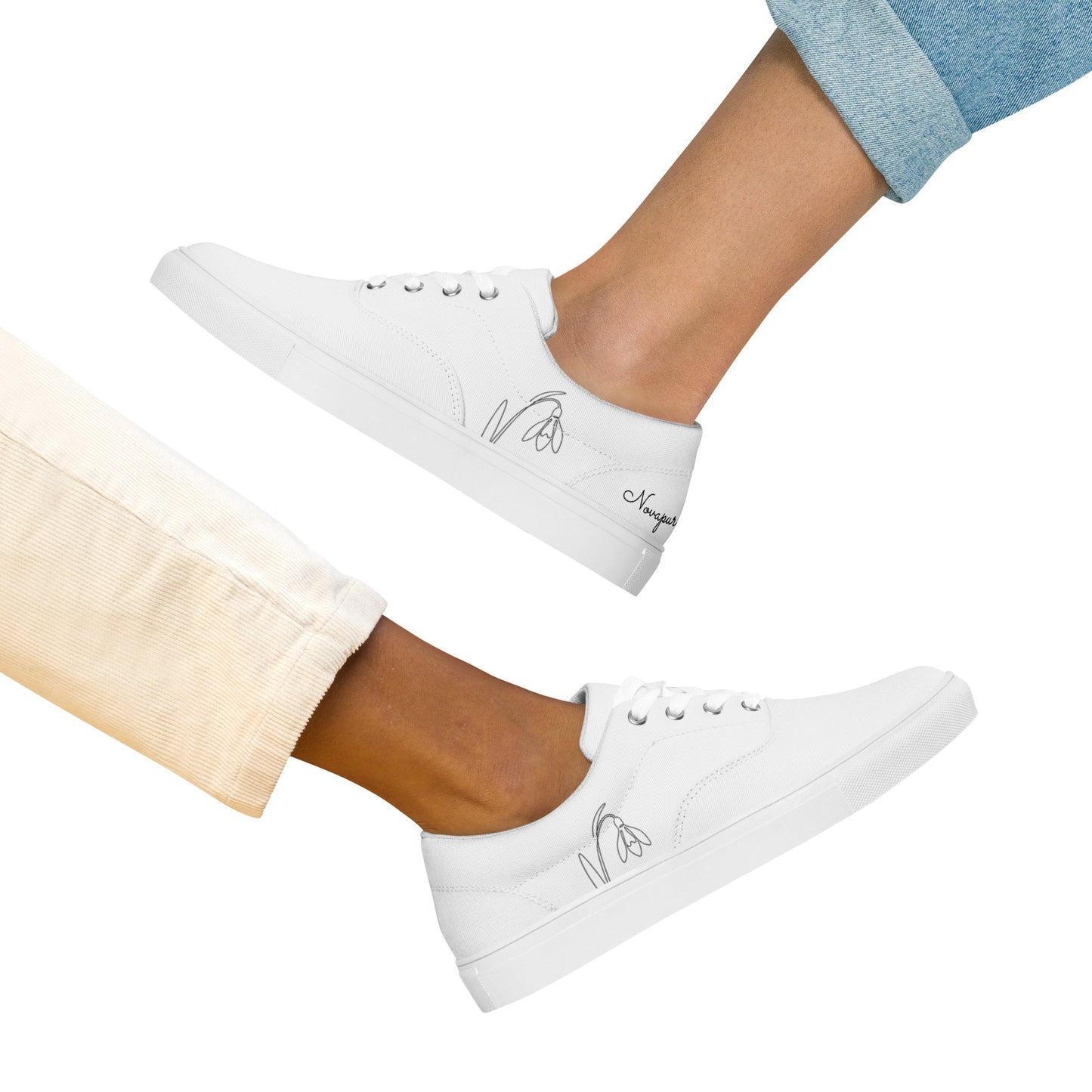 Minimalist white women's canvas sneakers with black First Bloom snowdrop design by Novapuro