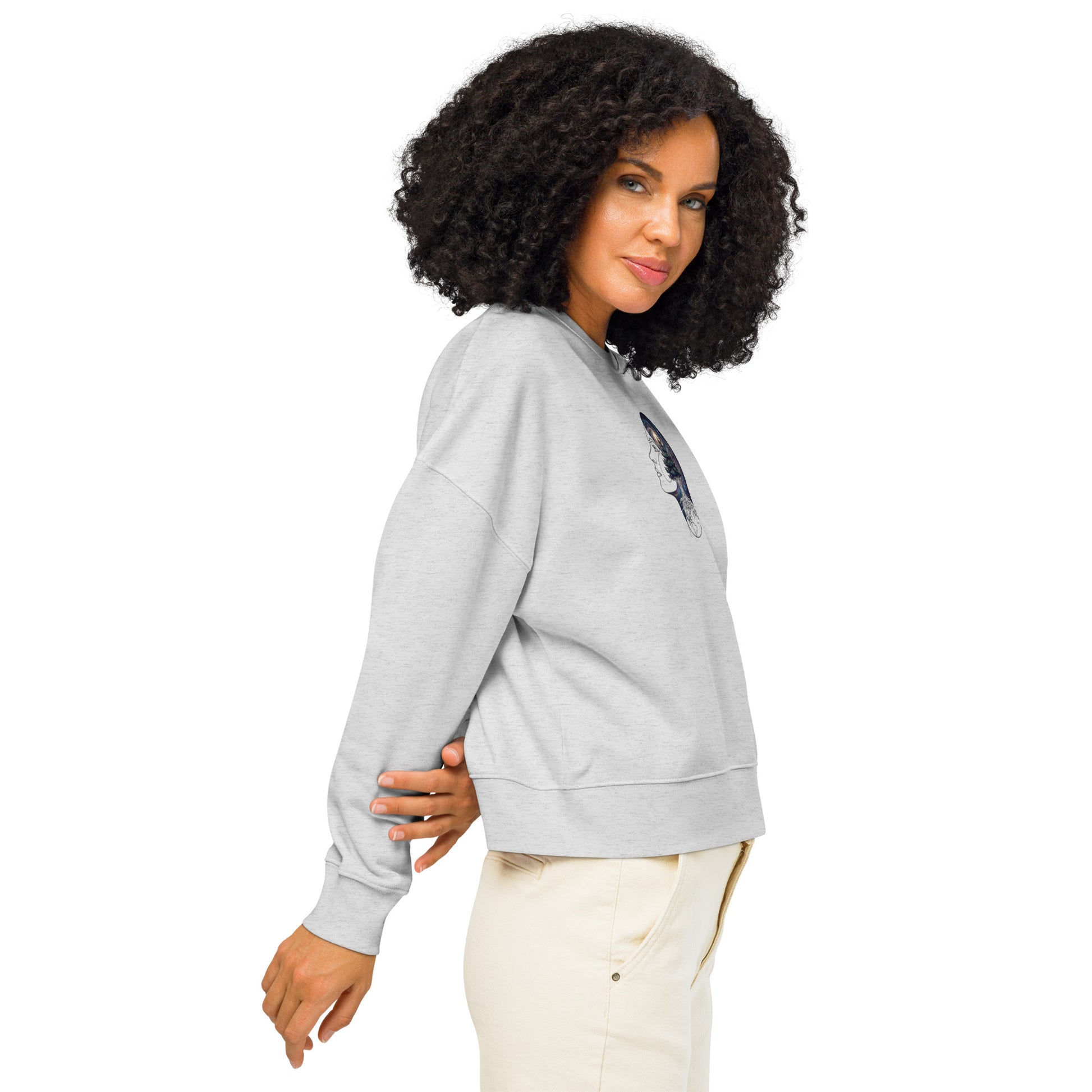 Side view of a woman wearing the white cosmic forest organic sweatshirt, showing the dropped shoulders and comfortable fit.