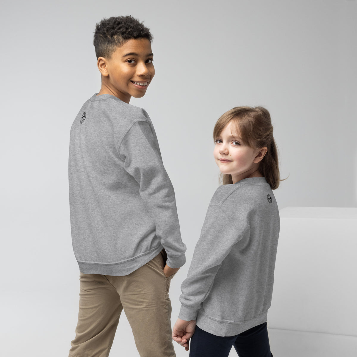Two children wearing the grey youth crewneck sweatshirts, side view.
